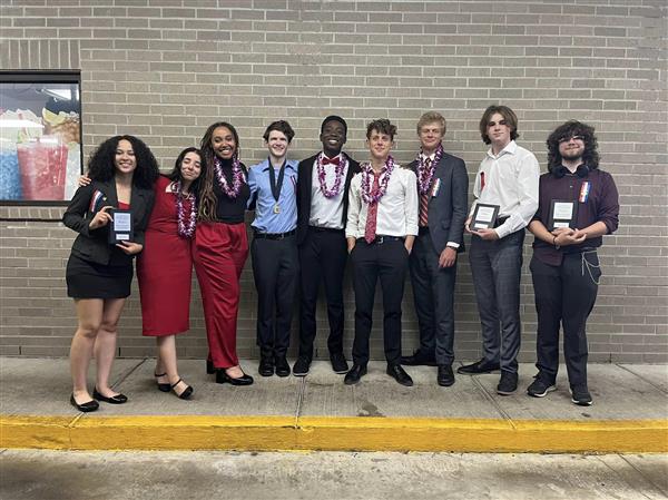 The Debate Team displays trophies