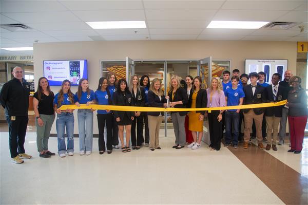 Group of students and staff at Kickapoo spirit store ribbon cutting