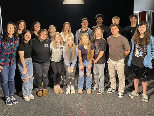 A group of students pose smiling at the camera.