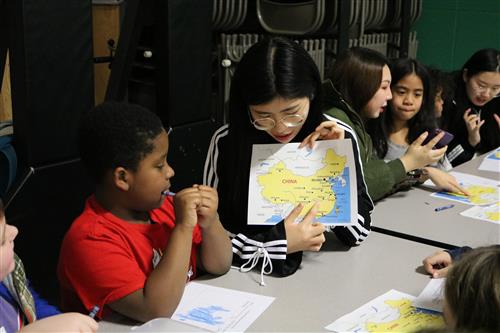 Cyrus with MSU student pointing at map 