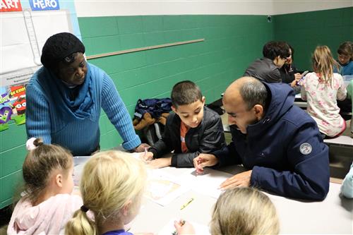 Student examining map with man from Saudi Arabia 