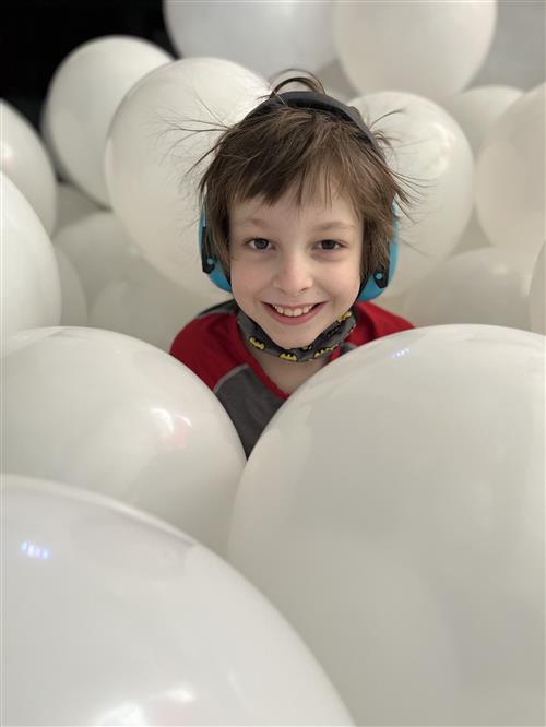 Student in balloons