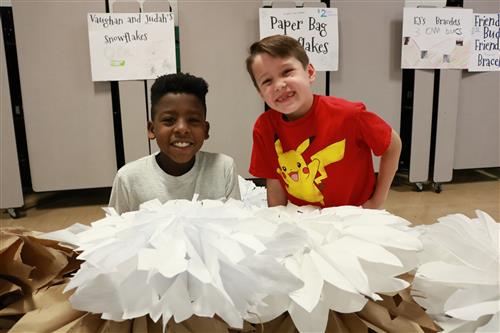 Smiling kids with big snowflakes 