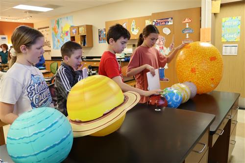 students use planet diameter data and measurement skills to create 2D paper models of planets to scale.