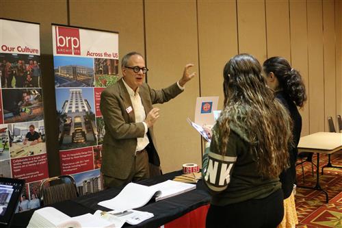 School board present speaks to students about architecture 