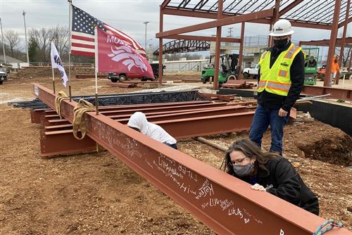 signing a steel beam 