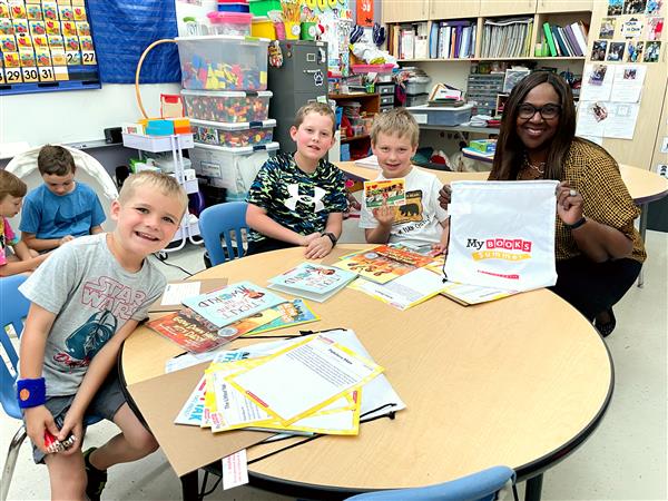  Dr. Grenita Lathan distributes Scholastic book bundles to students in grades K-5