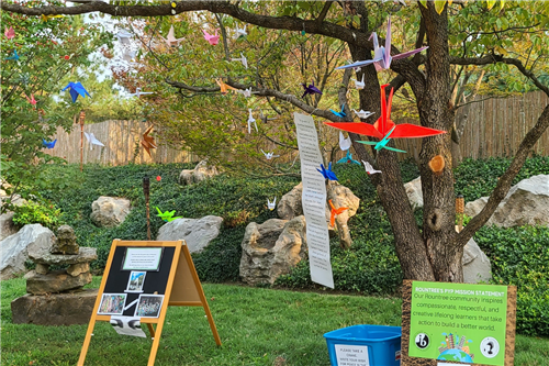 Paper cranes hanging from tree