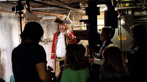 Students filming principal in pirate's costume 